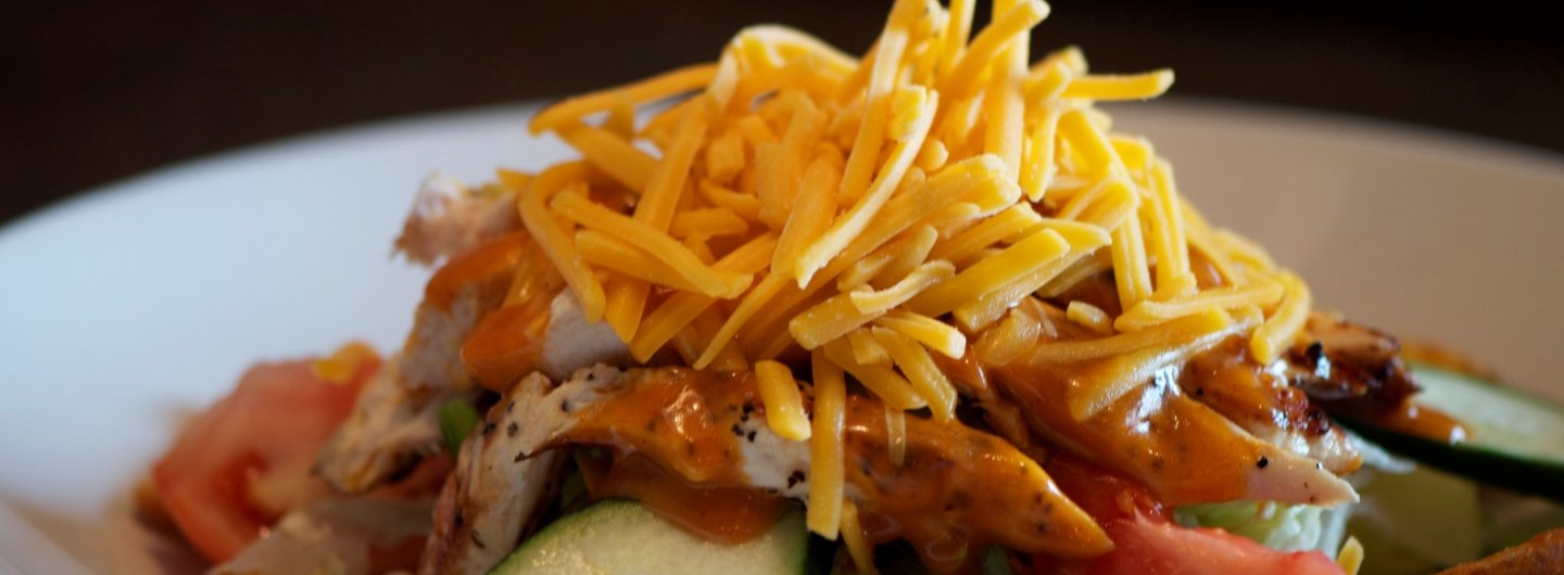 buffalo chicken salad with cucombers, cheese and tomatoes